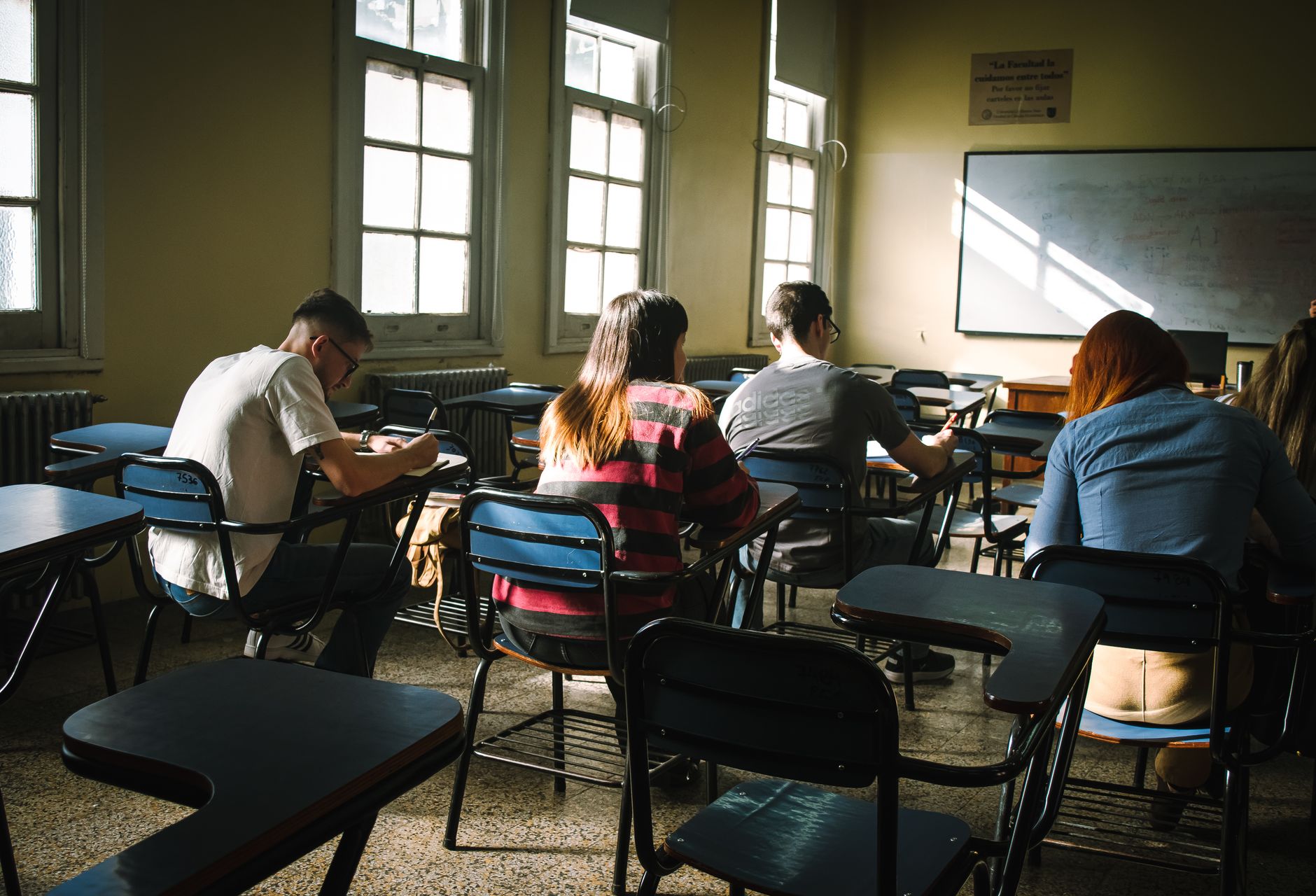 Aula de academia con alumnos estudiando oposiciones públicas